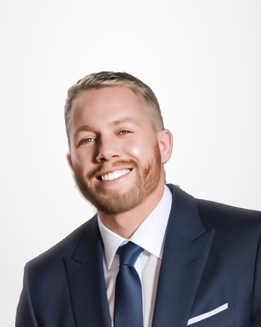 Ashton Harris in a navy suit, smiling